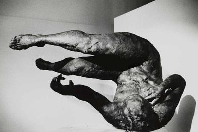 Statue of an upside down woman, presumably mid-tumble.