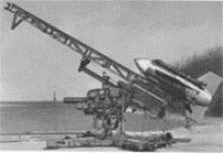 A cartoonish-looking rocket mounted on rail atop a tripod