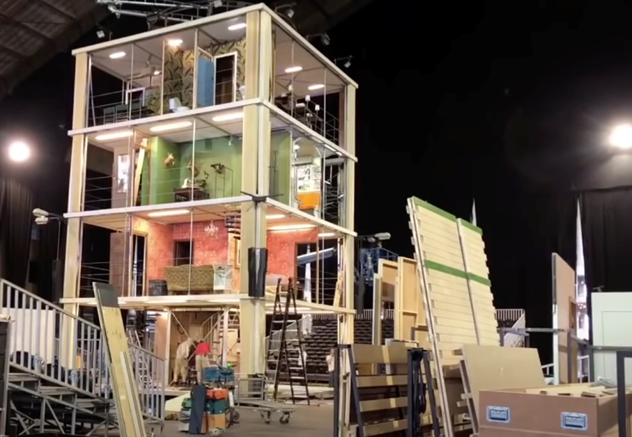 A theater set comprised of four rooms stacked on top of each other.